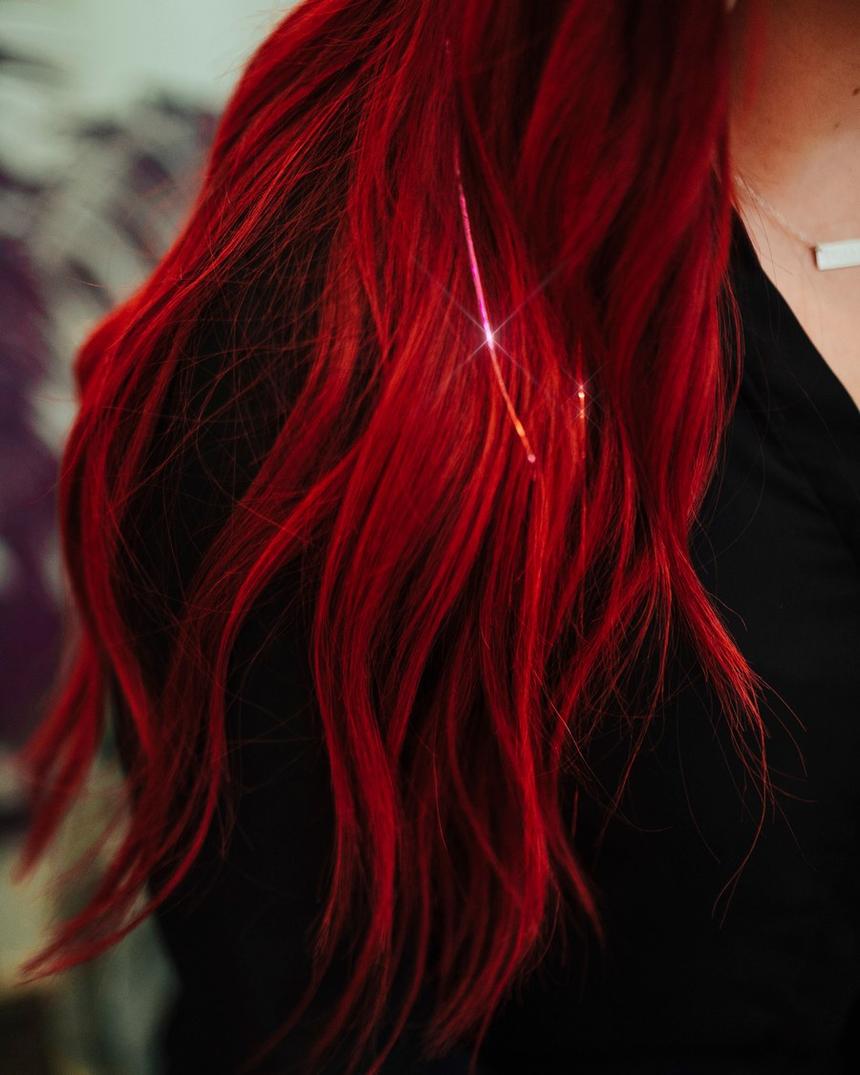 Bright red hair with sparkle strands catching the light