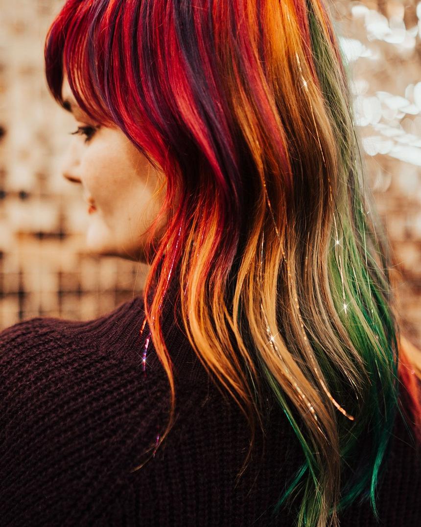 Rainbow colored hair threaded with gold sparkle strands